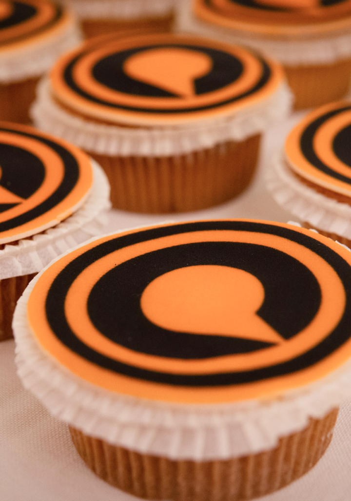 Cupcakes with Quickchannel logo on them